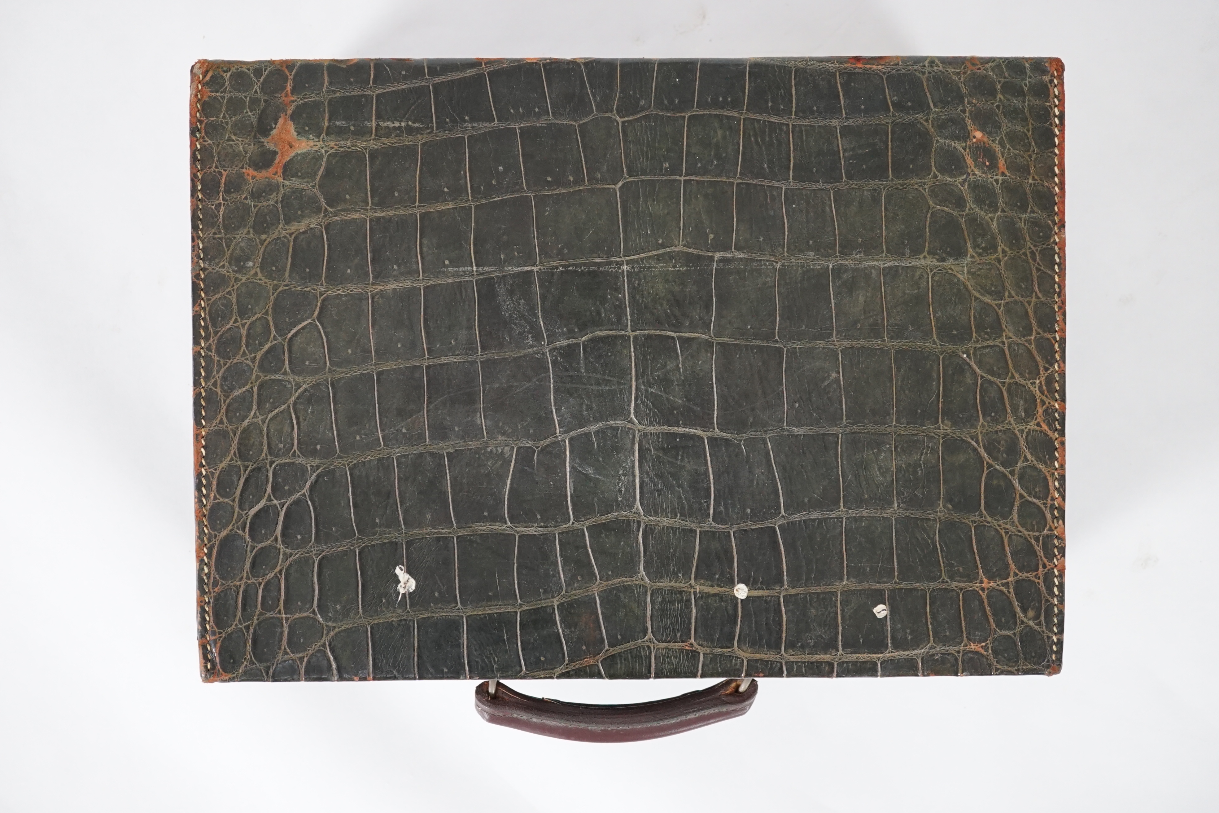 A George V green crocodile toilet case, 46cm x 33cm x 18cm